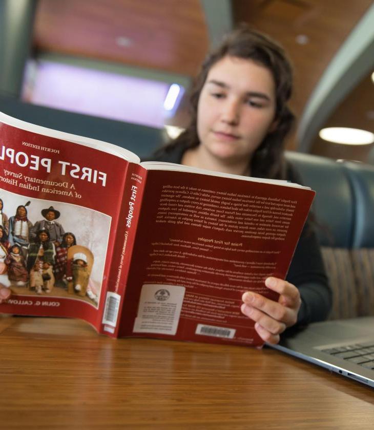 Student reading a textbook