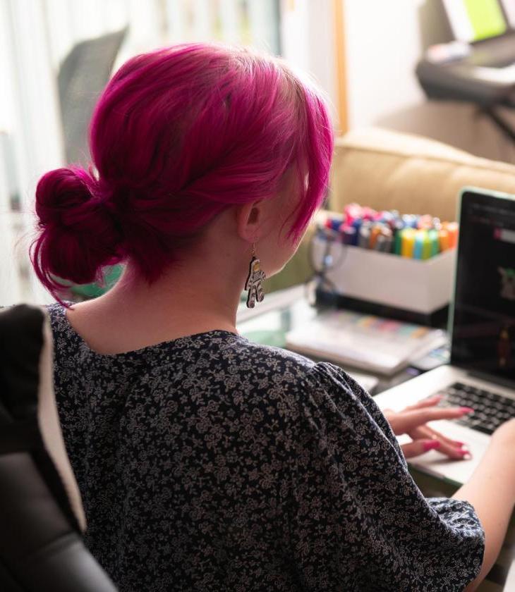 Student works at their computer in their dorm room.